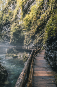 A picture of Vintgar Gorge in Slovenia with the wood walk way along side the river.