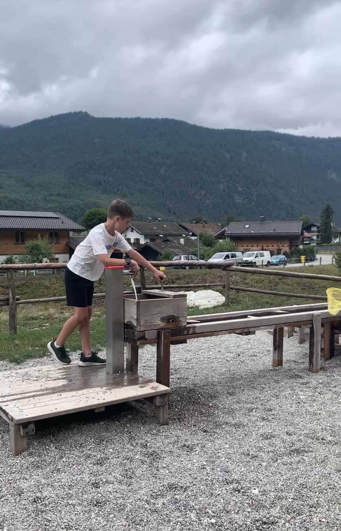 A boy playing at a water station at a park in Germany
