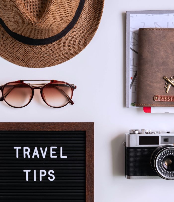Retro camera with  toy plane, map and passport on white background, Travel tips concept